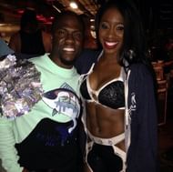 Naomi and Kevin Hart, with John Cena and Kane lurking in the background.